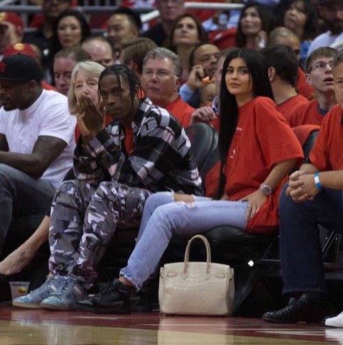 HOUSTON, TX - APRIL 25:  Houston rapper Travis Scott and Kylie Jenner watch courtside during Game Five of the Western Conference Quarterfinals game of the 2017 NBA Playoffs at Toyota Center on April 25, 2017 in Houston, Texas. NOTE TO USER: User expressly acknowledges and agrees that, by downloading and/or using this photograph, user is consenting to the terms and conditions of the Getty Images License Agreement.  (Photo by Bob Levey/Getty Images)